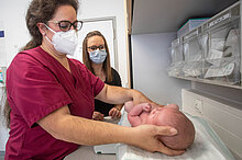 Hebamme mit Mutter und Kind